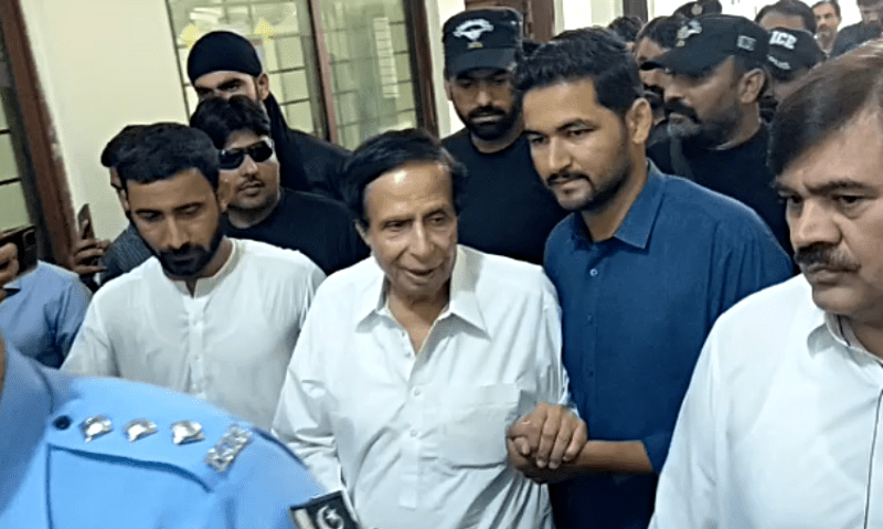 Parvez Elahi leaving the Islamabad High Court, the fleeting taste of freedom palpable but elusive. A white SUV in the background stands as an ominous symbol of the saga to come.